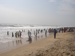 Devotees taking holy bath at Puri Beach