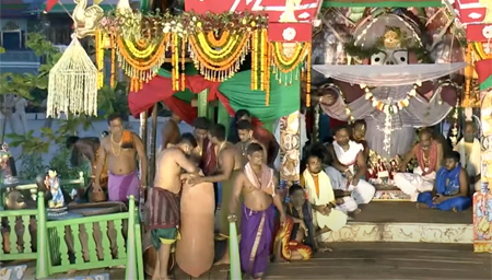Servitors preparing the earthen pot for Adhara Pana