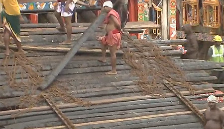 Servitors busy putting charamala for Adapa Bije