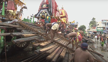 Servitors busy putting charamala for Adapa Bije