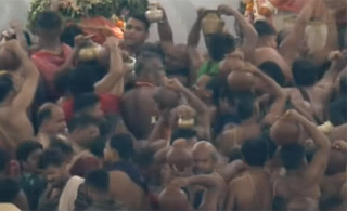 Servitors bringing water to Snana Mandapa